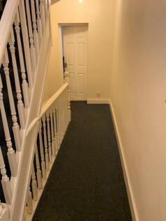 Well-maintained carpeted hallway and staircase ...