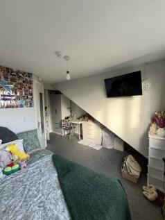 Cosy double bedroom with angled ceiling, mounte...