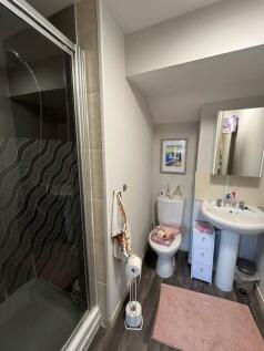 Well-kept bathroom with a walk-in shower, pedes...