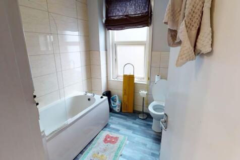 Bright, well-kept bathroom with a full bathtub,...