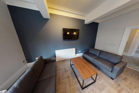 Contemporary communal living room with two grey...