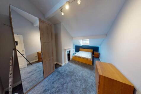 Bright, carpeted double bedroom in a loft-style...