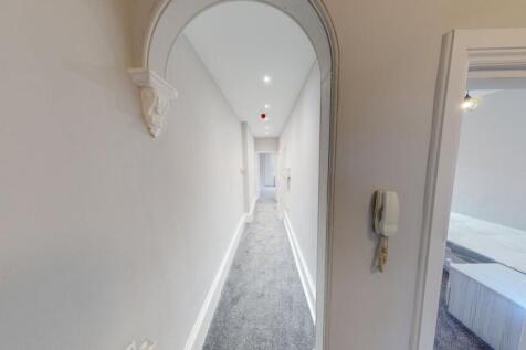 Bright, long internal hallway with neutral déco...