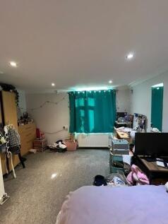 Bright, well-lit bedroom with carpeted floors, ...