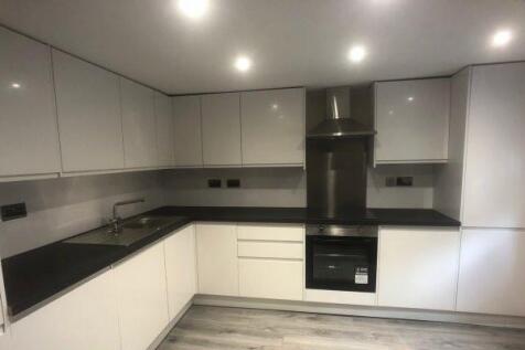 Modern fitted kitchen with glossy white cabinet...