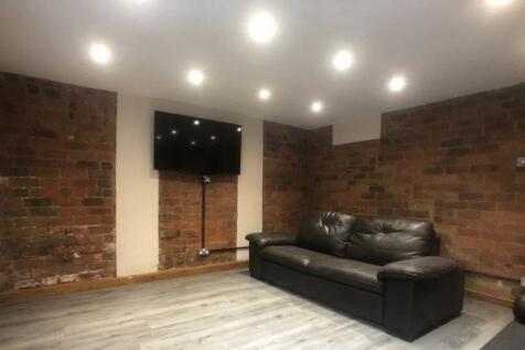 Cozy contemporary living area with exposed bric...