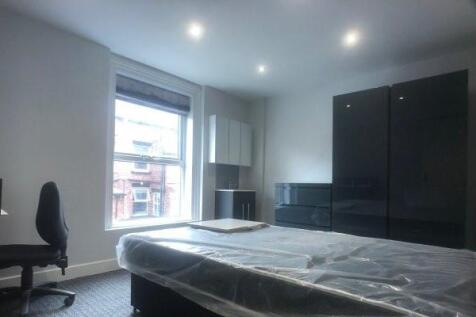 Bright, modern double bedroom with a large wind...