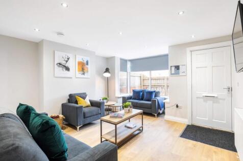 Bright, modern living room with wood flooring, ...