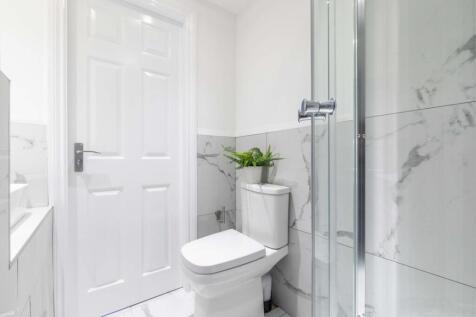 Bright, modern bathroom with a walk-in glass sh...