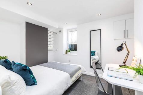 Bright, modern double bedroom with a comfortabl...