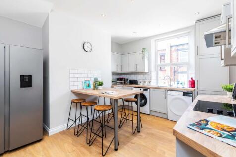 Bright, modern kitchen with large window, integ...