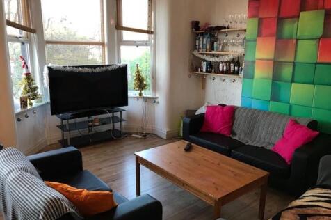 Bright, contemporary living room with a bay win...