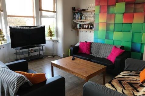 Bright, modern living room with colourful featu...