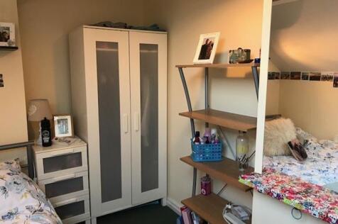 Bright, neatly arranged bedroom with complement...