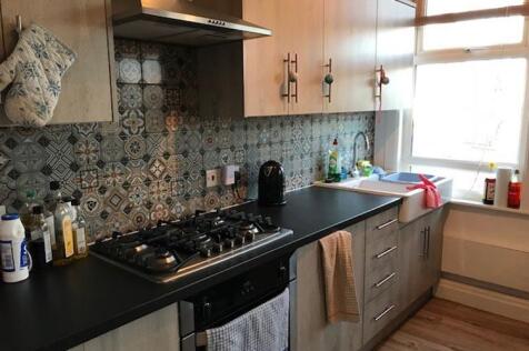 Modern galley-style kitchen with patterned tile...