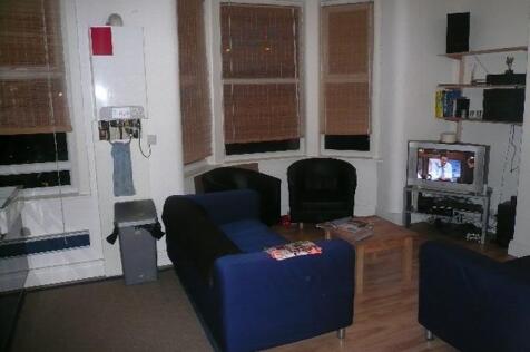 Cozy furnished living area with matching blue s...