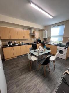 Bright, modern communal kitchen with ample stor...