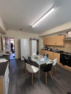 Bright communal kitchen with modern wood-effect...