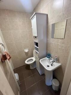 Well-maintained bathroom with neutral tiles, pe...