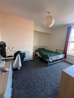 Bright, simply furnished bedroom with a metal-f...