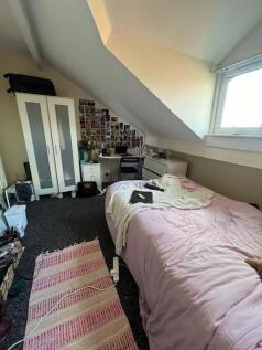Cozy attic bedroom with sloped ceiling, single ...