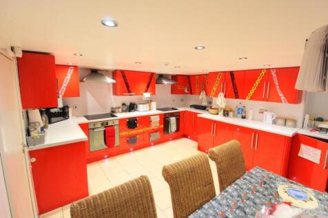 Bright modern kitchen with bold red fitted unit...