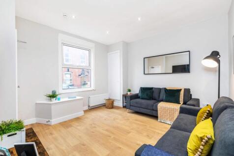 Bright, modern living room with light wood floo...