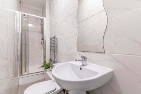 Bright, modern bathroom with a walk-in shower, ...