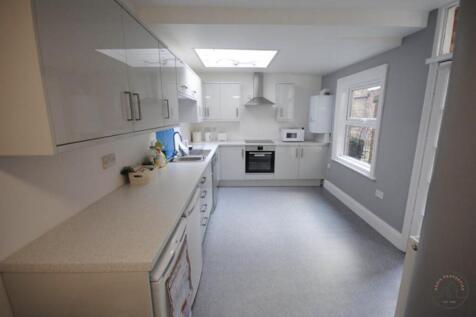 Bright modern kitchen with glossy cabinets, int...