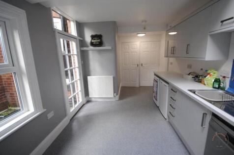 Bright, modern galley kitchen with large window...