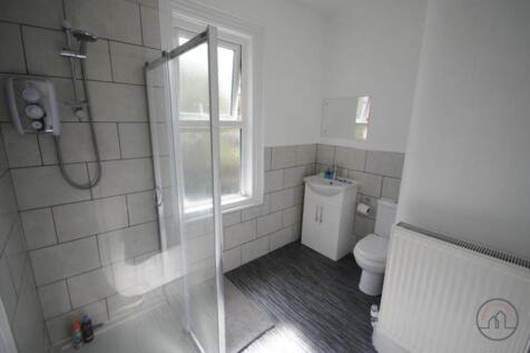 Modern bathroom with a walk-in shower, compact ...