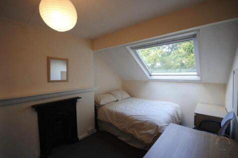 Cozy bedroom with a windowed dormer providing a...