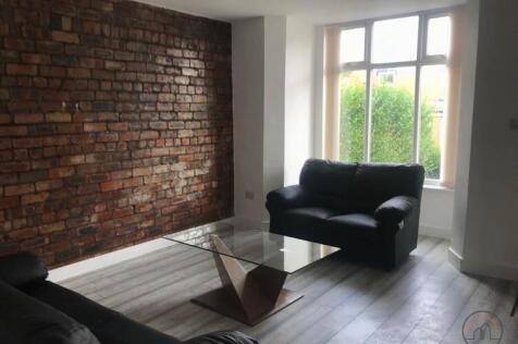 Bright, modern living room with an exposed bric...