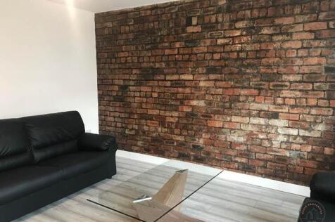 Contemporary living room with an exposed featur...