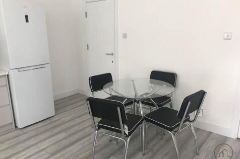 Bright kitchenette area with modern laminate fl...