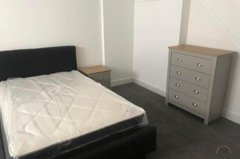 Bright, simple double bedroom with a modern uph...