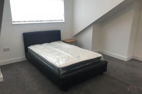 Neat, simply furnished bedroom with a modern si...