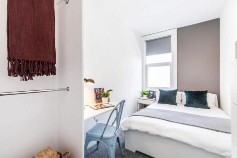 Bright, neatly presented bedroom with a comfort...