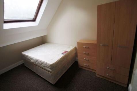 Bright attic bedroom with a sloped skylight pro...