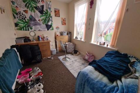 Cozy bedroom with two large windows letting in ...