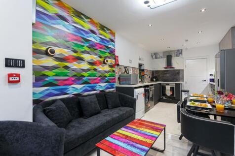 A vibrant and modern kitchen featuring artistic...