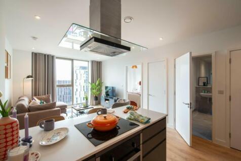 A spacious and well-lit modern living room with...
