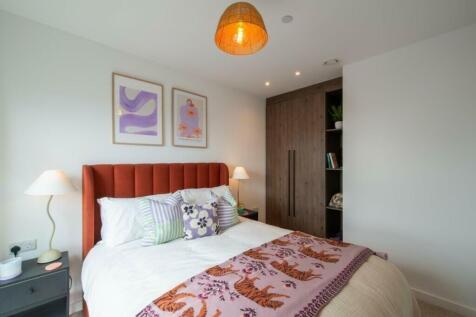 A cozy and well-decorated double bedroom featur...
