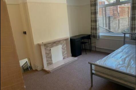 A spacious and well-lit double bedroom featurin...
