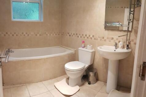 A spacious and clean bathroom featuring a bath,...