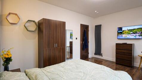 A bright and inviting double bedroom featuring ...