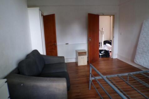 A spacious double bedroom featuring a cozy sofa...