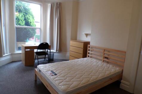 A spacious and bright double bedroom featuring ...