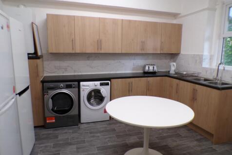 A modern kitchenette featuring ample storage an...