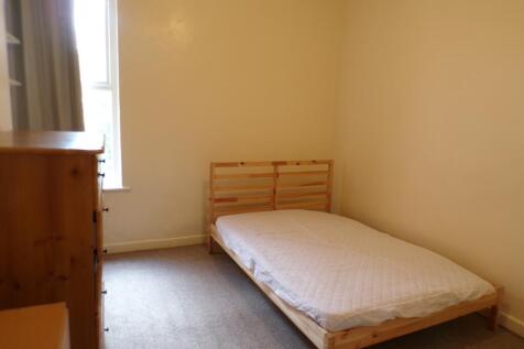 A cozy double bedroom with ample natural light,...